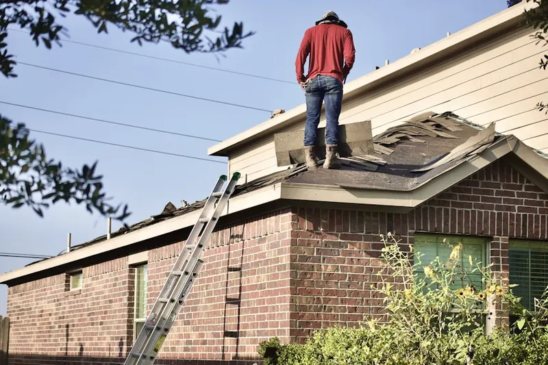 Professional roofer working on a residential roof in King George
